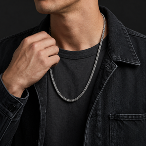 Long sterling silver Braid Chain necklace worn over a charcoal shirt with a dark denim jacket