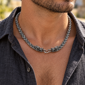 Close-up of sterling silver Dragon Chain necklace and dragon clasp worn with an open shirt