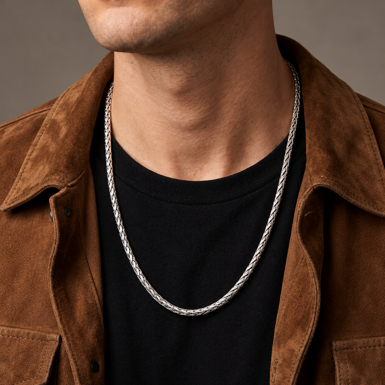 Sterling silver Dream Weave necklace worn over a black shirt with a brown suede jacket
