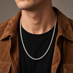 Sterling silver Dream Weave necklace worn over a black shirt with a brown suede jacket