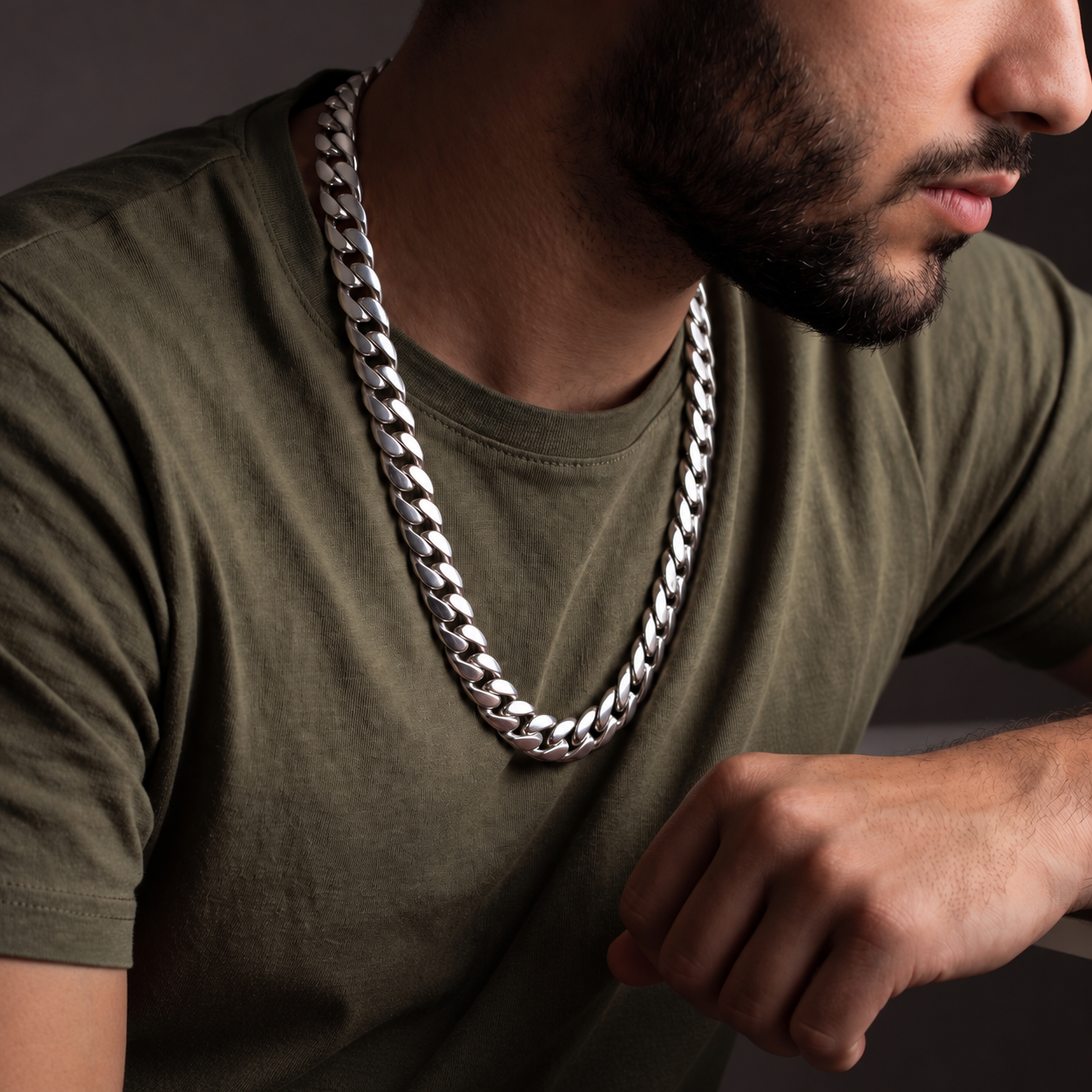 Man wearing a sterling silver High Class Chain necklace over an olive green shirt