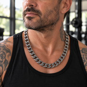 Tattooed man wearing a Lizard Skin sterling silver chain with a black tank top