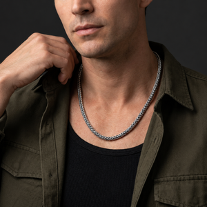 Man wearing a sterling silver Sterling Lasso necklace with an olive shirt