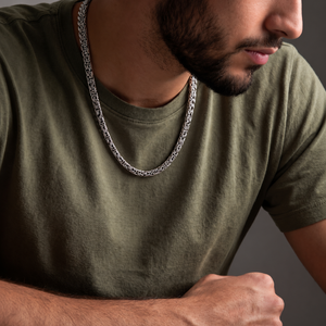 Man wearing a sterling silver Woven Rope Byzantine necklace with an olive green shirt